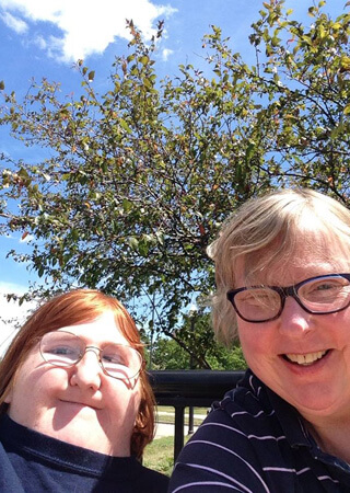 Mother and daughter taking a selfie at a park.